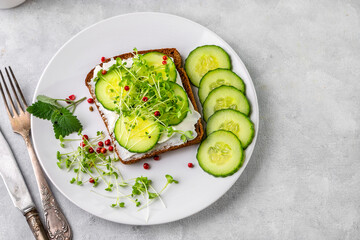 Sandwich with green baby sprouts, micro greens, cucumber and cream cheese. Delicious and healthy snack