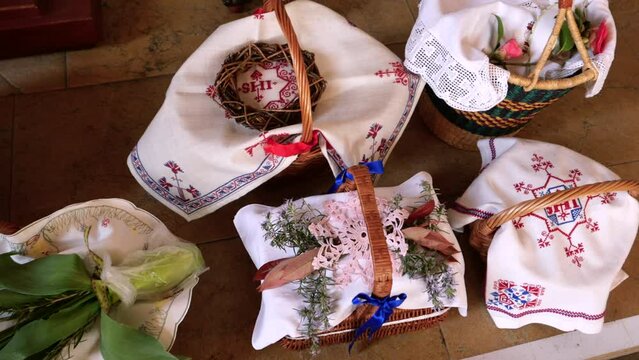 Olten, Switzerland - April 16, 2022: Baskets containing a sampling of Easter foods are brought to church to be blessed on Holy Saturday.
