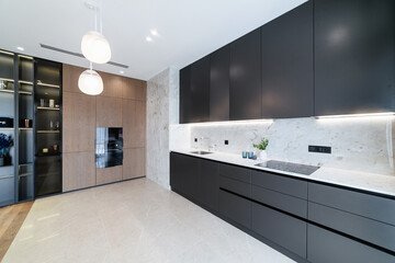 Black, modern, stylish kitchen with lighting