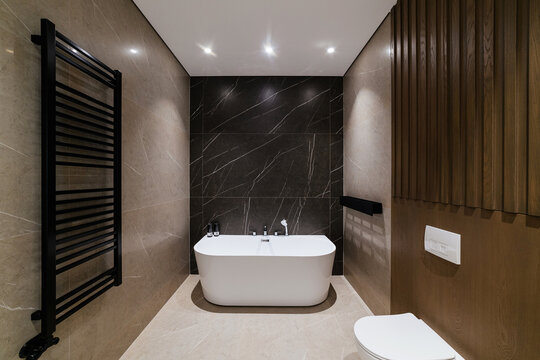 Modern Bathroom Design. White Bath On A Black Wall. Loft Style