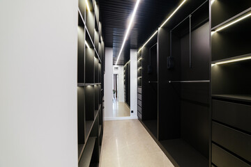 Black wardrobe with lighting. Modern interior design