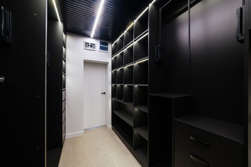 Many shelves for clothes in the wardrobe with lighting