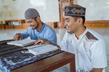 portrait of asian Man muslim learing to reading quran together during ramadan at the mosque with...