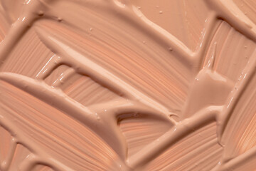 Beige nude liquid foundation texture, concealer smear smudge drop. Closeup macro. Cosmetic tonal...