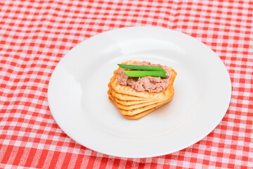 Crispy Salted Cracker with Liver Pate and Green Onions on White Plate. Easy Snack