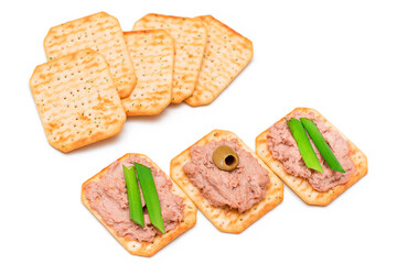 Crispy Salted Crackers with Liver Pate, Green Onions and Olives on White Plate. Easy Snack