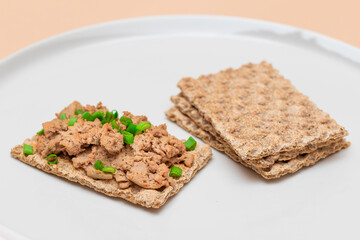 Crispy Sandwich with Chicken Pate and Green Onions on White Plate. Whole Grain Bread with Liver Pate. Diet Breakfast and Healthy Food