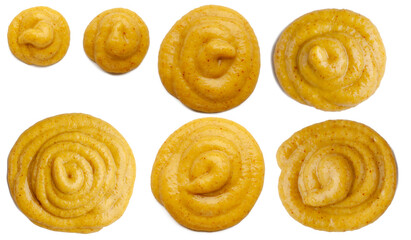 Mustard sauce in the form of circles. Collection of mustard sauce circles, different sizes, isolated on white background.