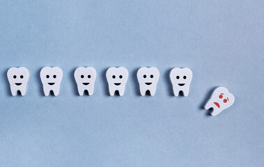 Tooth loss. Teeth row with fallen baby milk or adult one on blue background. Cavity, poor oral...