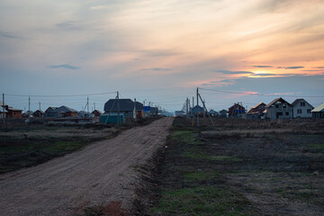 Sunset in a newly built village, new houses in the private sector.