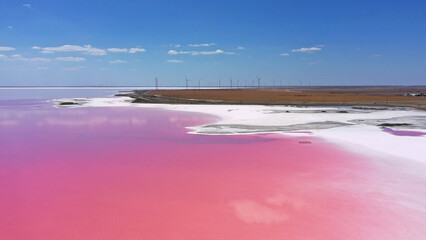 Aerial view of White salt on the shores of the island in Pink Island and blue sky . Lake Lemuria, Ukraine. Lake naturally turns pink due to salts and small crustacean Artemia in the water