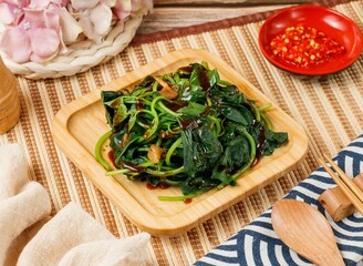 blanched vegetables spinach in tomato chili in a bowl isolated on mat side view on wooden table taiwan food
