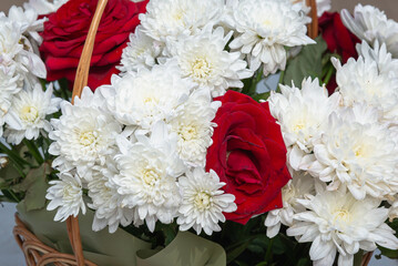 Flowers in a basket, white and red.
