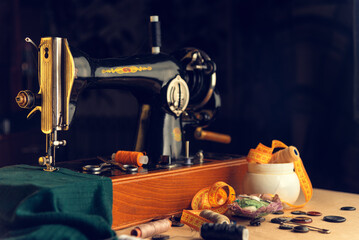 An old retro sewing machine with a place and items for a dressmaker.