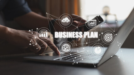 Business plan showing a person working on a laptop is included.