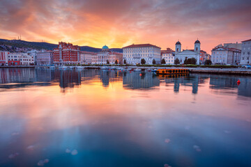 Trieste, Italy. Cityscape image of downtown Trieste, Italy at dramatic sunrise. - obrazy, fototapety, plakaty