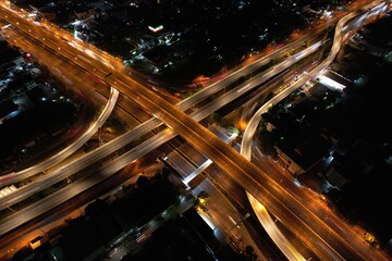Fototapeta na wymiar car traffic transportation above intersection road in Bangkok city night, aerial view cityscape of advanced innovation, financial technology