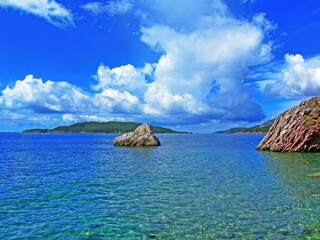 The coast in Montenegro. Rocky coast with beaches of the Adriatic Sea. On a sunny day. Beautiful view photo wallpaper. Sea shore. Wild nature sea ocean