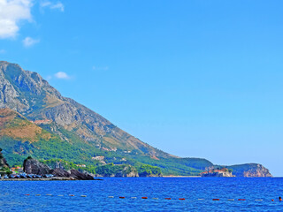 The coast in Montenegro. Rocky coast with beaches of the Adriatic Sea. On a sunny day. Beautiful view photo wallpaper. Sea shore. Wild nature sea ocean