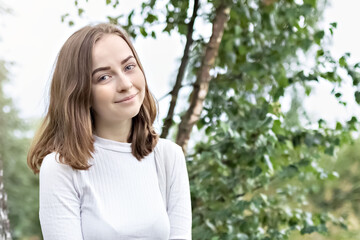 Fototapeta premium Portrait of a young teenager girl in the park. Spring.