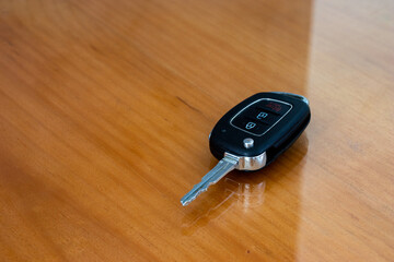 Car key on the table. - obrazy, fototapety, plakaty