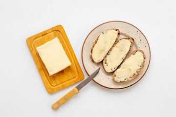 Spreading butter with knife on toast bread. Top view