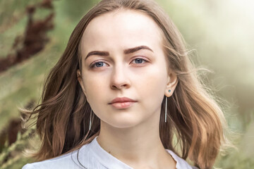 Fototapeta premium Portrait of a young teenager girl in the park. Spring.