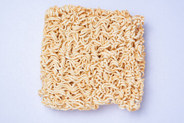 Uncooked instant noodles on white background.