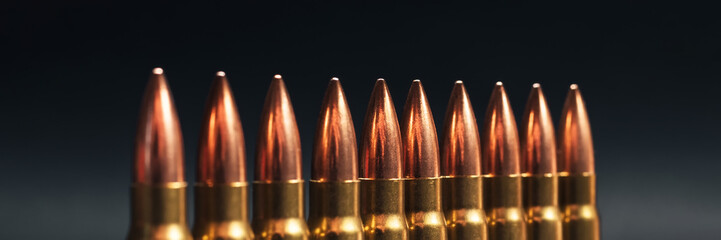 Bullets on gray background banner. Cartridges 7.62 caliber for Kalashnikov assault rifle panoramic...