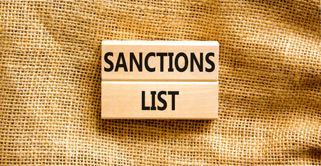 Sanctions list symbol. Wooden blocks with concept words Sanctions list on beautiful canvas background. Business political sanctions list concept. Copy space.