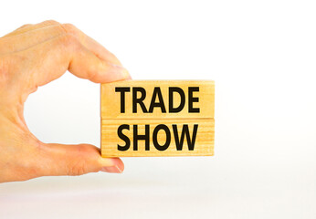 Trade show symbol. Wooden blocks with concept words Trade show on beautiful white background. Businessman hand. Business economic financial trade show concept. Copy space.