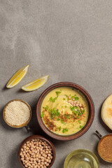 Hummus, fava or cream soup from chechivitsa. Top view on a gray background, a copy of the space