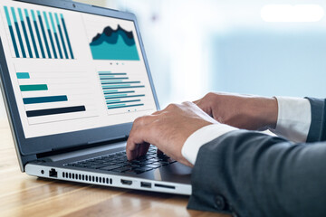 Close up photo of businessman using laptop and computer. Concept of data chart statistics and...