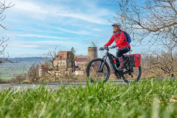 nice city woman on a cycling tour on the famous German route of castles, in front of the medieval...