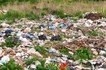 Defocus huge ruins, wreck in Ukraine, war. House after russian attack. Large garbage pile on nature green grass background, global warming. Pollution. Trash. Kyiv home. Consumerism. Out of focus