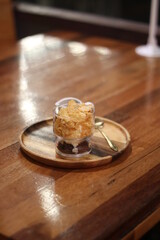 Closeup of Iced Caramel Macchiato at the coffee shop, Caramel Macchiato is a classic macchiato beverage. It consists of vanilla syrup, espresso, steamed milk, foam, and caramel drizzle
