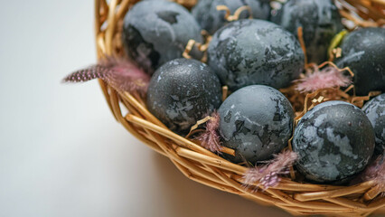 Easter card with a copy of the place for the text. Purple, blue eggs in a basket on a white background. Natural dye karkade tea.