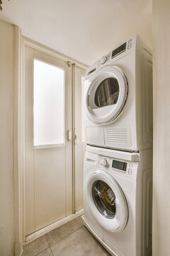 A Small Corner For A Laundry Room With Washing And Drying Machines In A Cozy Residential Apartment