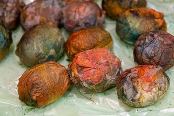 Easter egg dyeing, wrapping in fabric, Latvia