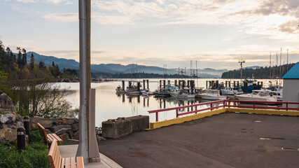 Obraz premium Reflections on the waters of Juan de Fuca Straits, viewed at Sooke Harbor, BC, early on a Spring morning.