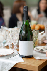 Champagne bottle on the table with blank label
