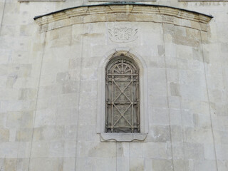 Fototapeta na wymiar Arch Church Window with a Beautiful Grating