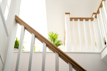 Shallow focus of a wooden stair banister seen looking into a newly converted loft conversion. A...