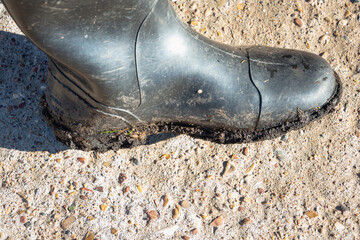 Boots in the mud after a hike in the forest.
