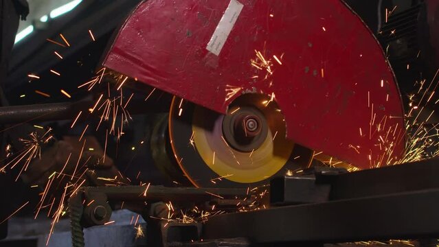 close-up, cutting of metal structures, making homemade armor plate by professional worker using a cutting machine. cutting work with smooth equipment for steel metal, iron, sparks in a heavy industry
