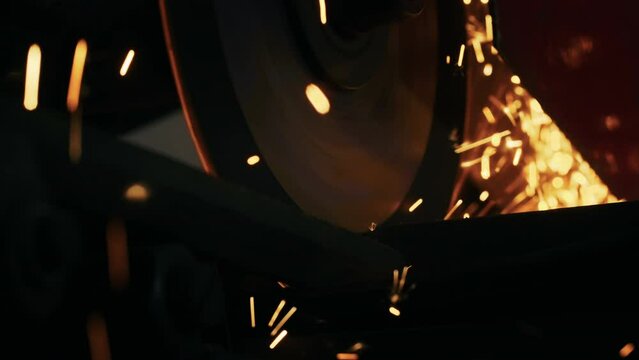 close-up, cutting of metal structures, making homemade armor plate by professional worker using a cutting machine. cutting work with smooth equipment for steel metal, iron, sparks in a heavy industry
