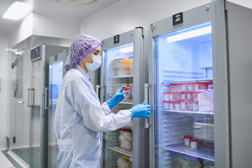 A girl scientist checks a sample for research