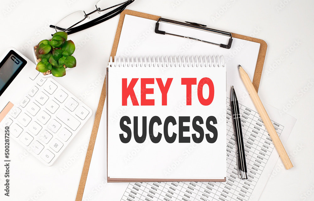 Aufkleber office desk table with paper sheet, notepad ,chart and calculator. top view key to success