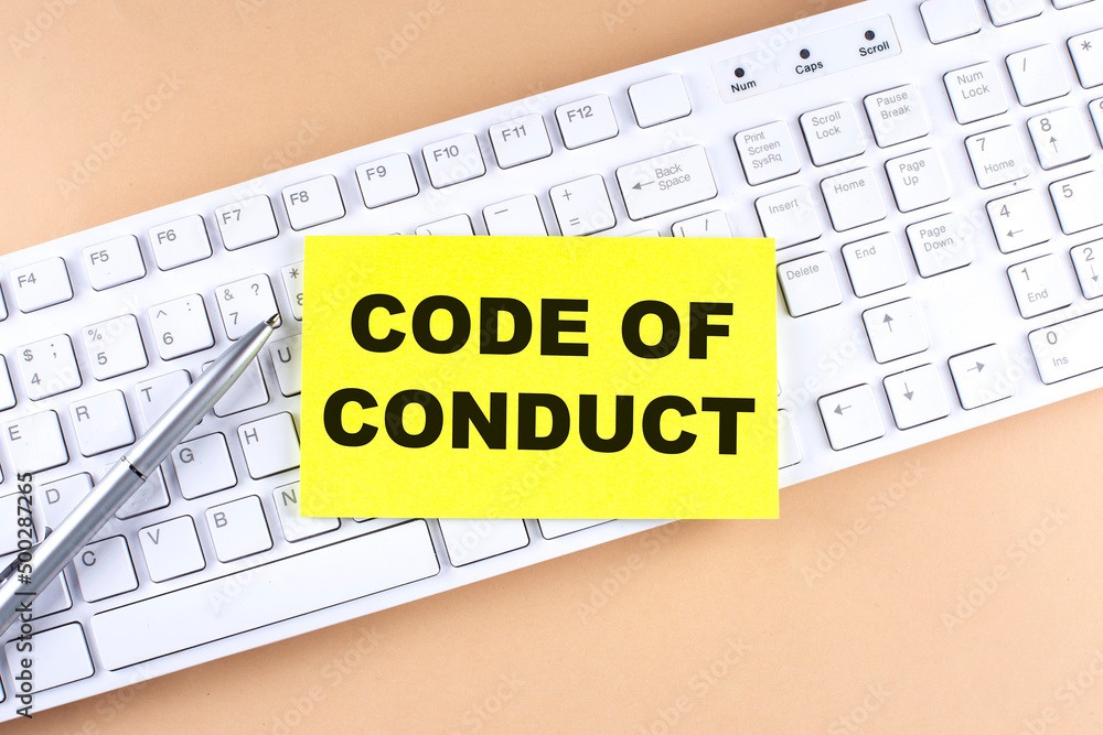 Poster text code of conduct text on a sticky on keyboard, business concept