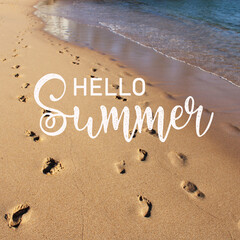 Sea sand with footprints background with Hello Summer lettering